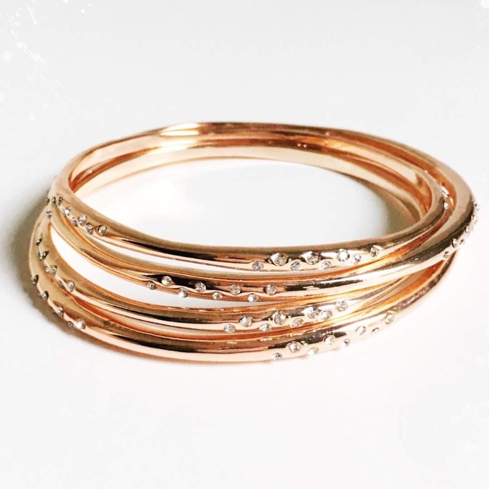 Single rose gold bangle with Cubic zirconia stones. Image is of 4 stacked.